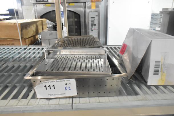 Two brand new stainless steel straining bins, scratch and dent condition, perforated design, auction lot #111, QTY x2.