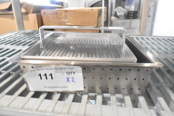 Brand new stainless steel straining bins, scratch and dent condition. Perforated design, metal handles, lot of 2.