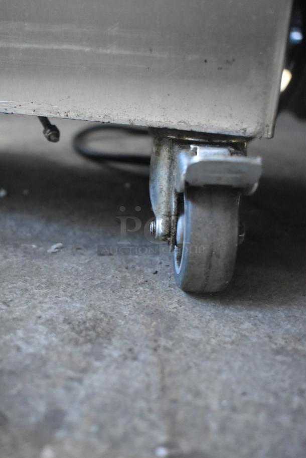 Jun-Air 87R-4MN1-HSBHH Nitro Generator on commercial caster, stainless steel, 120V, 1 Phase, close-up of wheel.