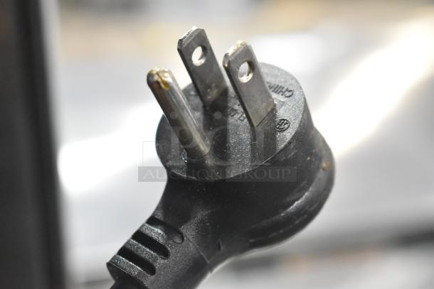 Close-up of a three-pronged power plug for a 2023 True T-23F-HC commercial freezer, showing standard 115V connector.