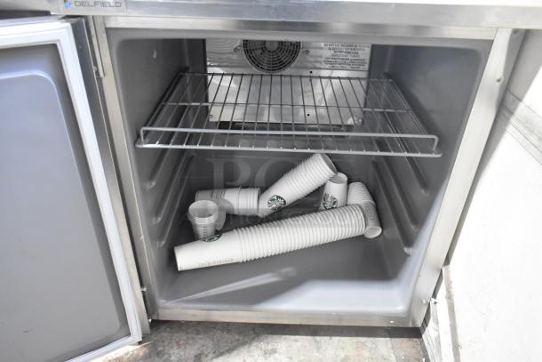 2020 Delfield stainless steel single door undercounter cooler, on commercial casters. 115 volts, 1 phase, interior shelf visible.