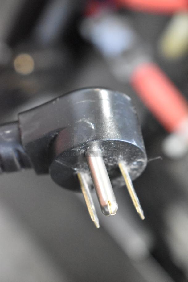 Close-up of a power plug for a 115-volt Delfield Stainless Steel Undercounter Cooler.