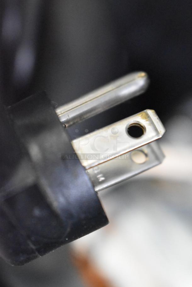 Close-up of a power plug for a Delfield 406P-STAR2 stainless steel undercounter cooler.