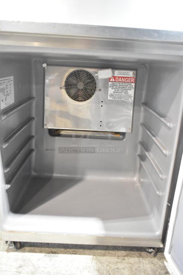 2020 Delfield 406P-STAR4 stainless steel commercial undercounter cooler with casters, single door, 115V, 1 phase. Visible fan and warning label.