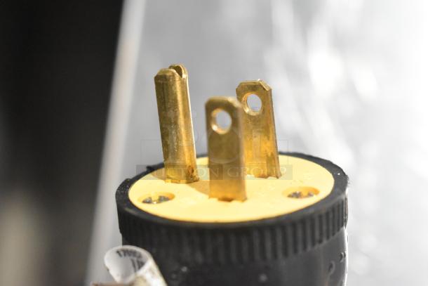 Close-up of a yellow electrical plug prong for the Delfield 406P-STAR4 undercounter cooler.