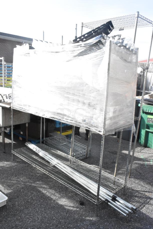 Chrome finish 3-tier shelving unit with poles, wrapped, buyer must dismantle. Consider freight charges.