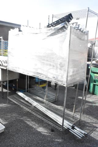 Chrome finish 3-tier shelving unit with poles, wrapped, buyer must dismantle. Consider freight charges.