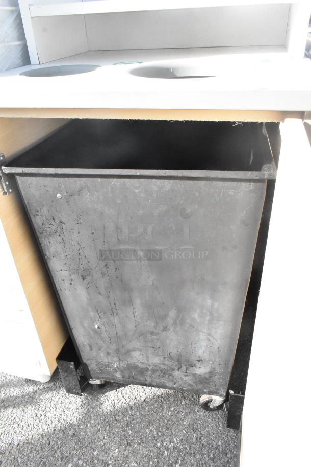 Trash can shell with deposit hole, tray slide, and door. Includes a large black trash can with wheels. Visible wear.