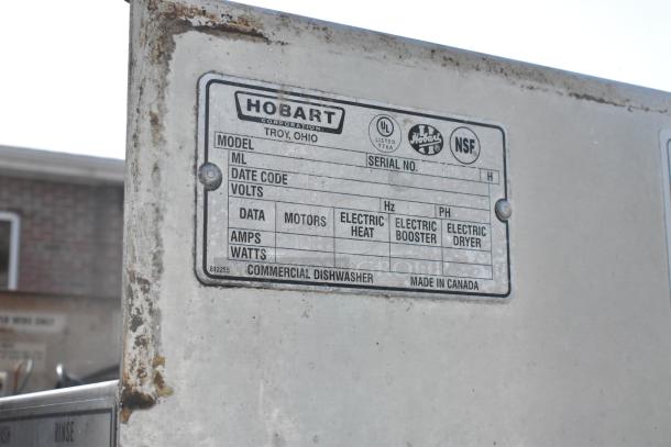 Hobart C44A conveyor dishwasher. Stainless steel, 208V, 3-phase. Visible label indicates UL and NSF certifications.