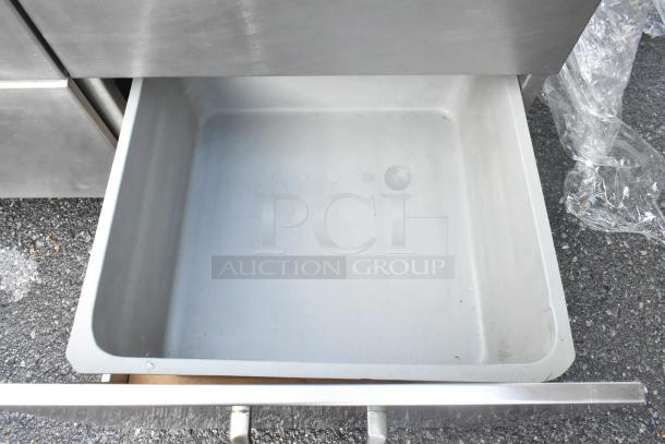 Stainless Steel 4 Drawer Counter, open drawer view. Features durable construction, ample storage space. Good condition.