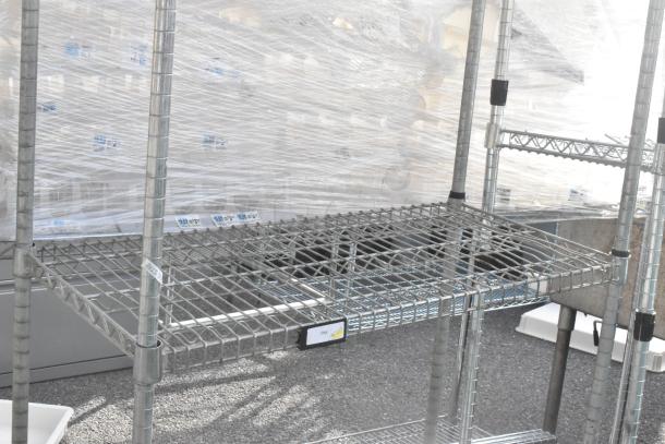 Chrome finish 2-tier wire shelving unit with sturdy metal construction. Buyer must dismantle; shipping considerations apply.