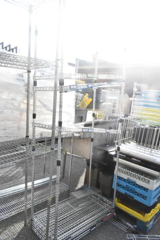 Chrome finish 5 tier wire shelving unit, in good condition, with visible labels. Buyer must dismantle for shipping.