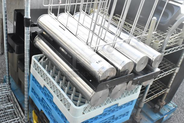 Pallet lot with dish caddies, stainless steel cup dispenser dolly, and a metal rack in used condition.