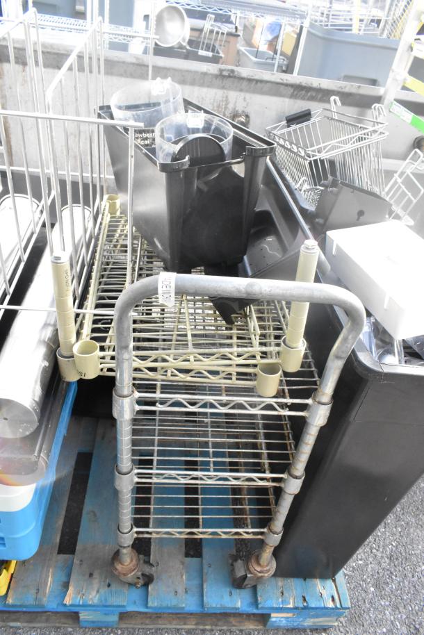 Pallet lot with dish caddies, cup dispenser dolly, and metal rack, all assembled on a wooden pallet, mixed condition.