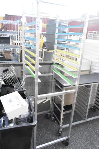 Metal commercial pan transport rack on durable casters, multiple slots for pans, used condition, tag showing item number 141.
