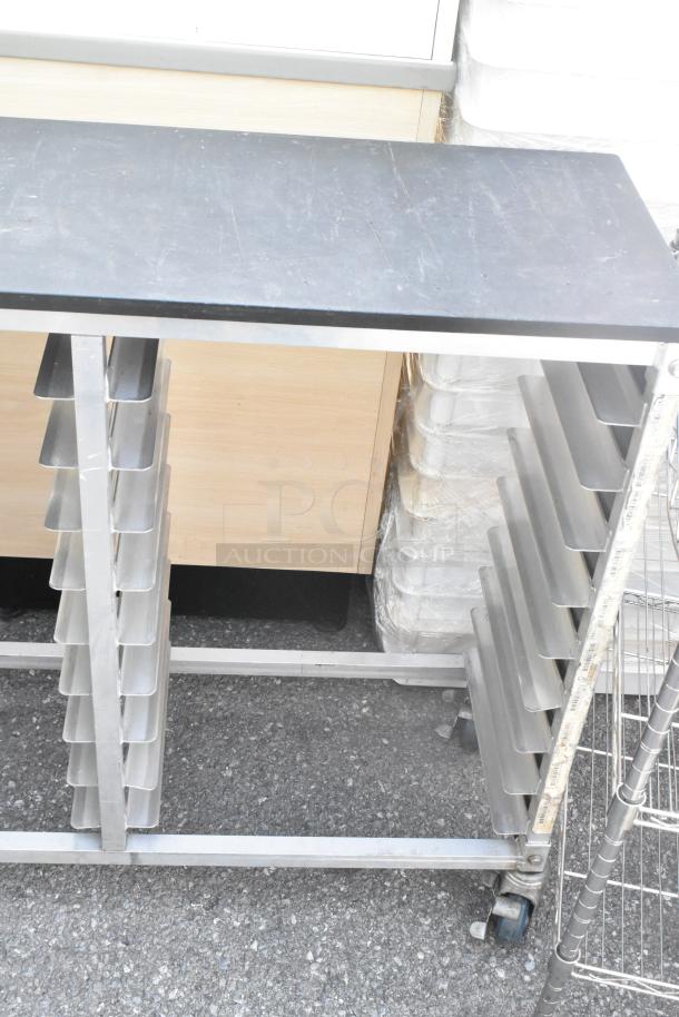 Metal commercial double pan transport rack on casters. Multiple tray slots, sturdy metal frame, used condition.