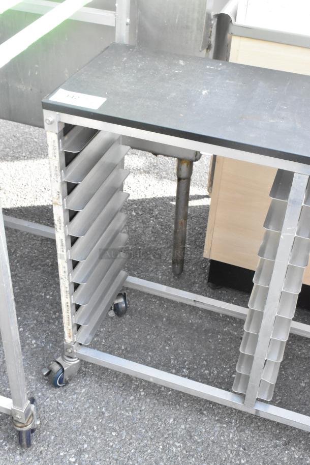 Metal commercial double pan transport rack with commercial casters, featuring multiple slots for pans, in used condition.