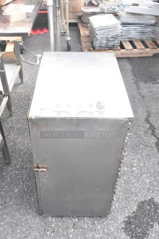 Metal portable enclosed pan rack, durable construction, visible hinge and latch, signs of wear, unit number 147.