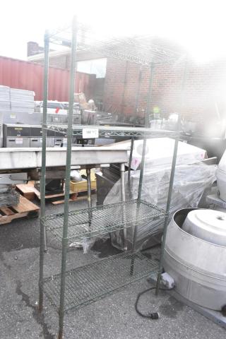 Green finish 4 tier wire shelving unit in used condition, outdoors. Buyer must dismantle; freight not included.