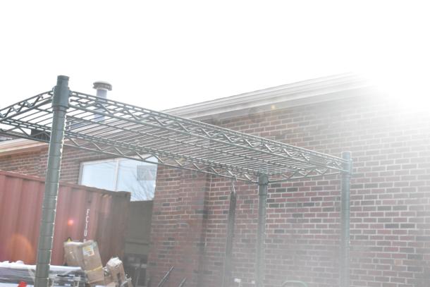 Green finish 4-tier wire shelving unit outside, sturdy metal construction, requires buyer dismantling.