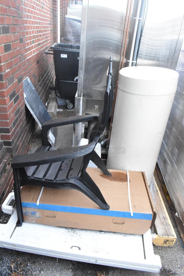 Pallet lot with Ecolab HDCARE Conic Bag Dispenser, Eaton SCB1457009, and a black patio chair. New with minor scratches.