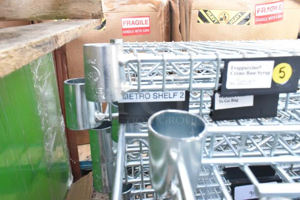 Chrome finish wire shelves on pallet, labeled "METRO SHELF 2," in new condition. Fragile and handling labels visible.