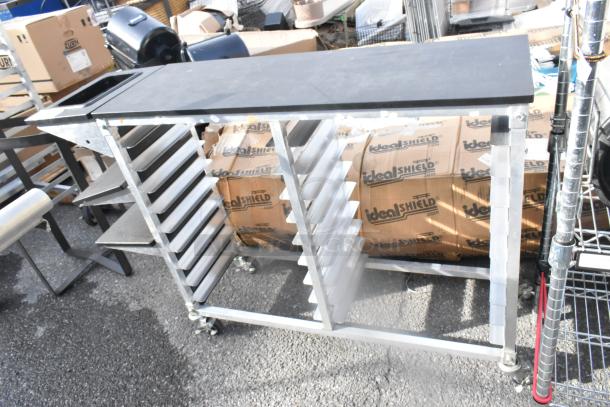 Metal double pan rack on commercial casters, featuring sturdy construction, multiple shelves for pans, and maneuverability.