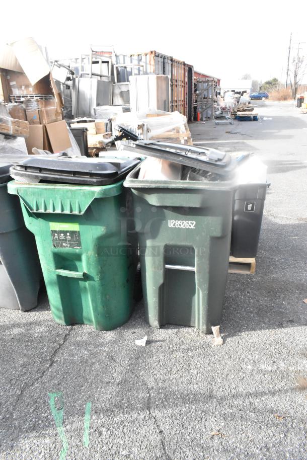 Two large green poly trash cans with lids and visible contents. Good condition, one labeled "U2892652." Multiple items included.