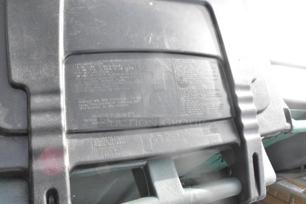 Two black Poly trash cans with visible manufacturer instructions and maximum load of 224 lbs. Includes contents.