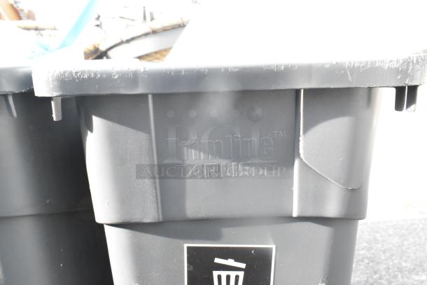 Pallet lot featuring Trimline Carlisle trash cans; includes basket on stand, beverage dispensers. Visible branding on containers.