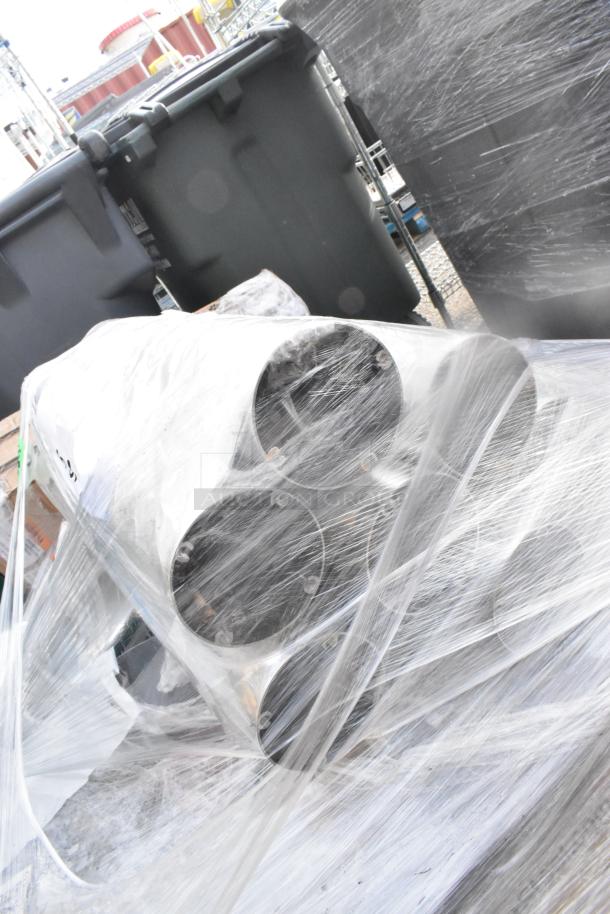 Pallet of wrapped items, including Holland Bar Stool EuroSlim 32" x 32" white faux marble tables and espresso high chairs.