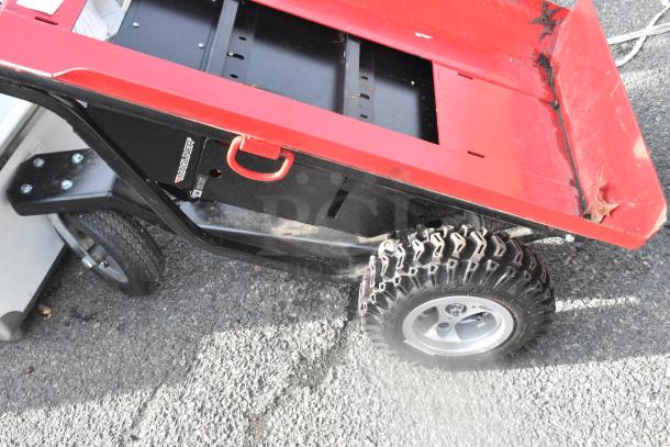 Brand new Magliner MHT75CB motorized hand truck, 1,000 lb. capacity, 13" aggressive tread pneumatic wheels, red plate, includes visible scratches and dents.