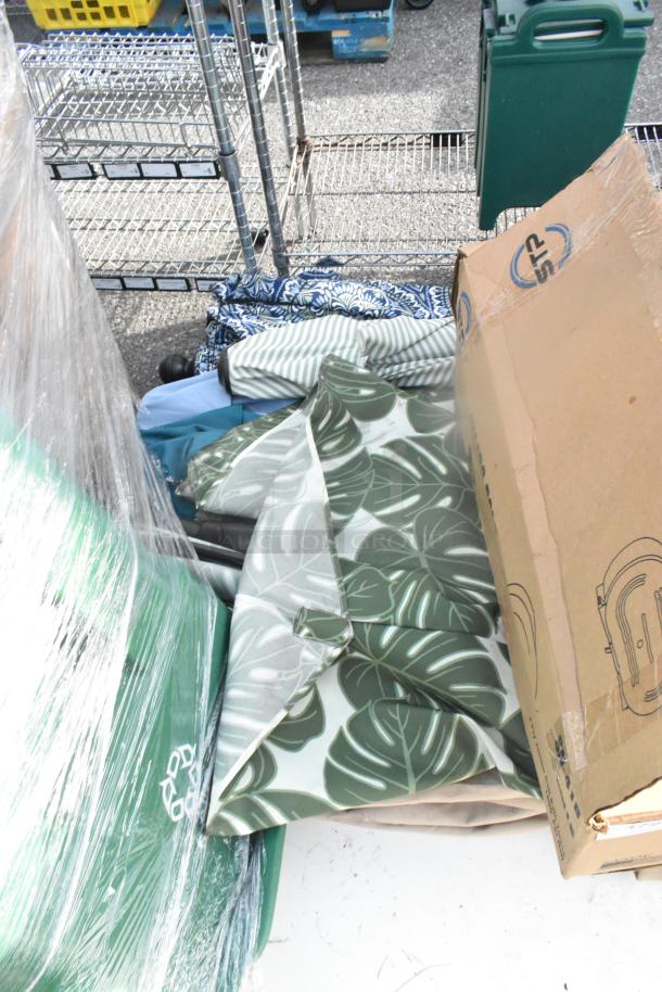 14 mixed items including wrapped Signicade A-frame sidewalk sign and various bins, fabrics, and cardboard boxes.