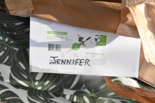 Box labeled "BRDUAL-V," containing Zephyr dual foil inflator with gauge. Brown paper wrapping, "JENNIFER" handwritten.