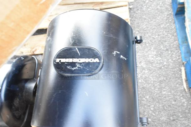 Black Marcal poly wall mount paper towel dispenser, visible surface scratches, Wonderfile label.