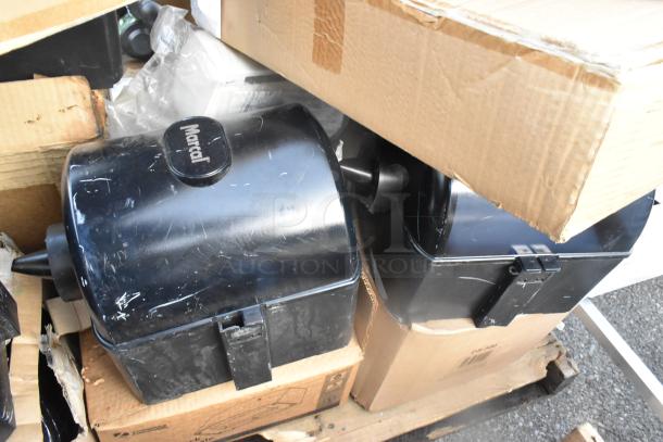 Marcal poly wall mount paper towel dispensers, black, slightly scratched, visible brand logo, in cardboard packaging.