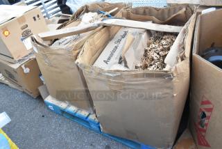 Damaged American Standard boxes on pallets, containing packing material. Visible markings and taped edges.