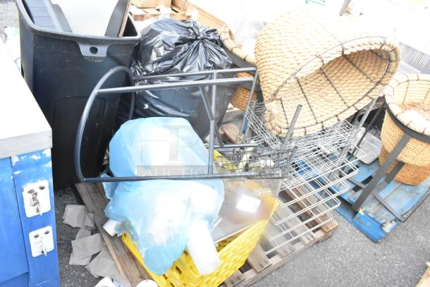 Pallet lot with various items including a metal stand, wire baskets, wicker basket, and a poly bin, all in used condition.