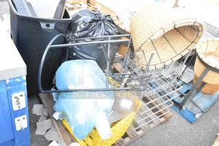 Pallet lot with various items including a metal stand, wire baskets, wicker basket, and a poly bin, all in used condition.