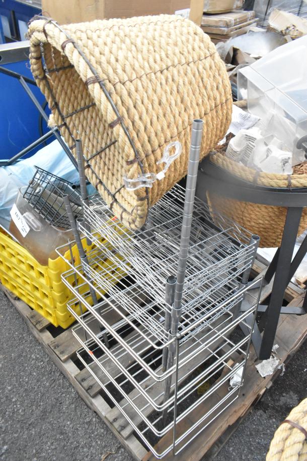 Pallet lot with wire baskets, wicker basket, poly bin, and metal stand. Various items, mixed condition.