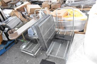 Two chrome finish wire flat carts without wheels, loaded with assorted items. Some packaging and shipping materials visible. Auction lot.