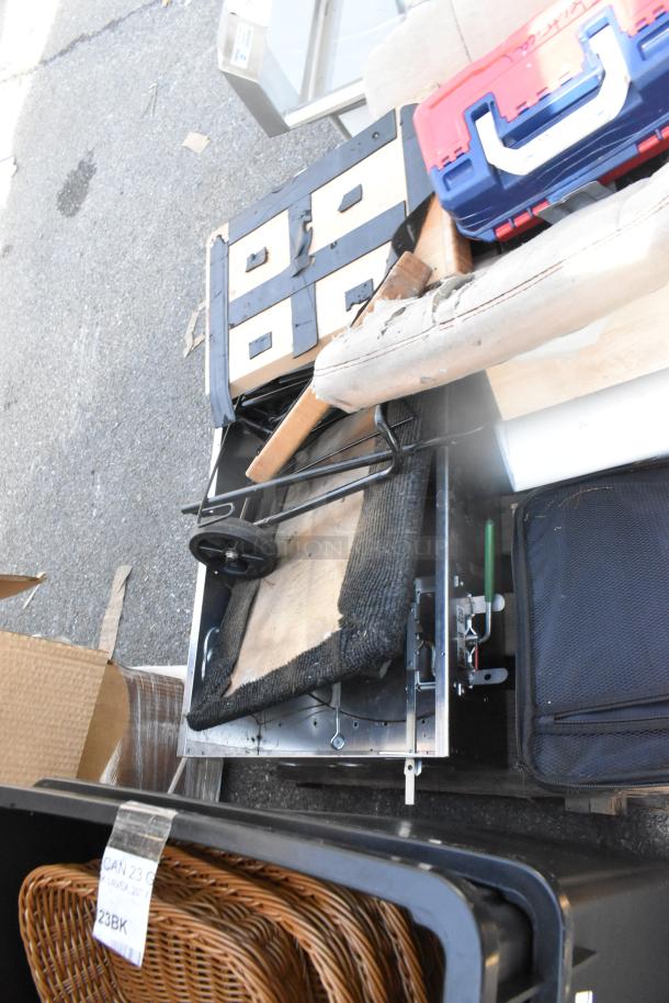 Assorted auction items including seat cushions, gray 12-drawer cubby, toolbox, and wicker baskets. Various conditions.