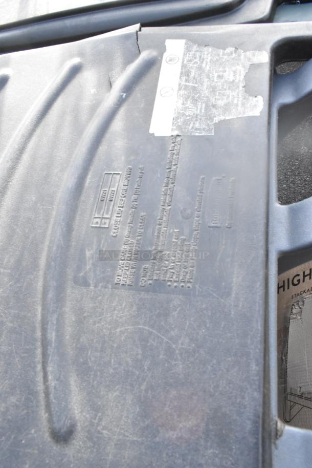 Two black Poly trash cans with visible labels and markings, showing light wear. Auction offer: bid once, receive two cans.