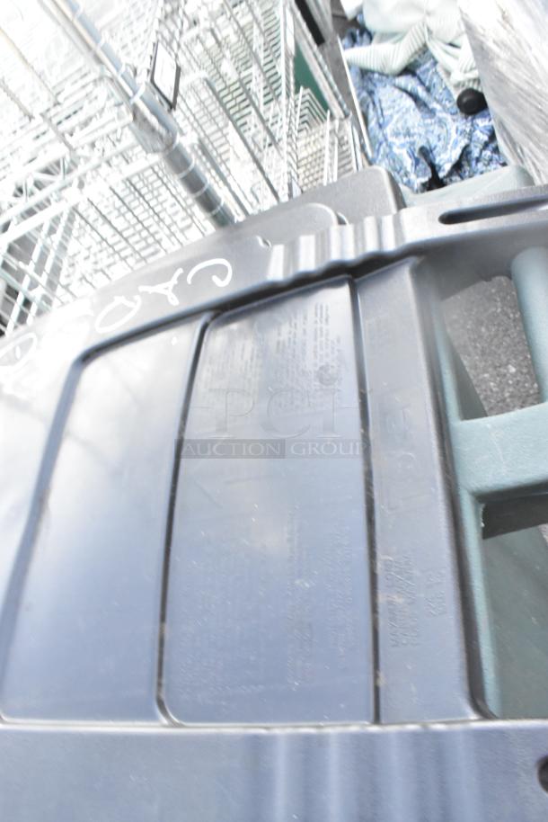 Two black poly trash cans with lids, stackable, minor scuffs, label details visible. Offers double bid value.