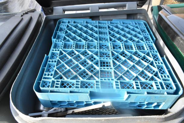 Two gray poly trash cans with open lids, containing blue plastic grid inserts; sturdy and in good condition.
