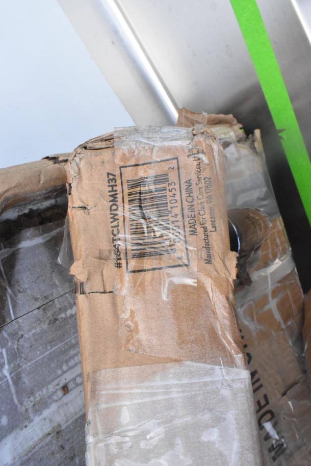Damaged box with visible barcode and "Made in China" marking, containing scratch and dent Steelton sink and Regency stand.