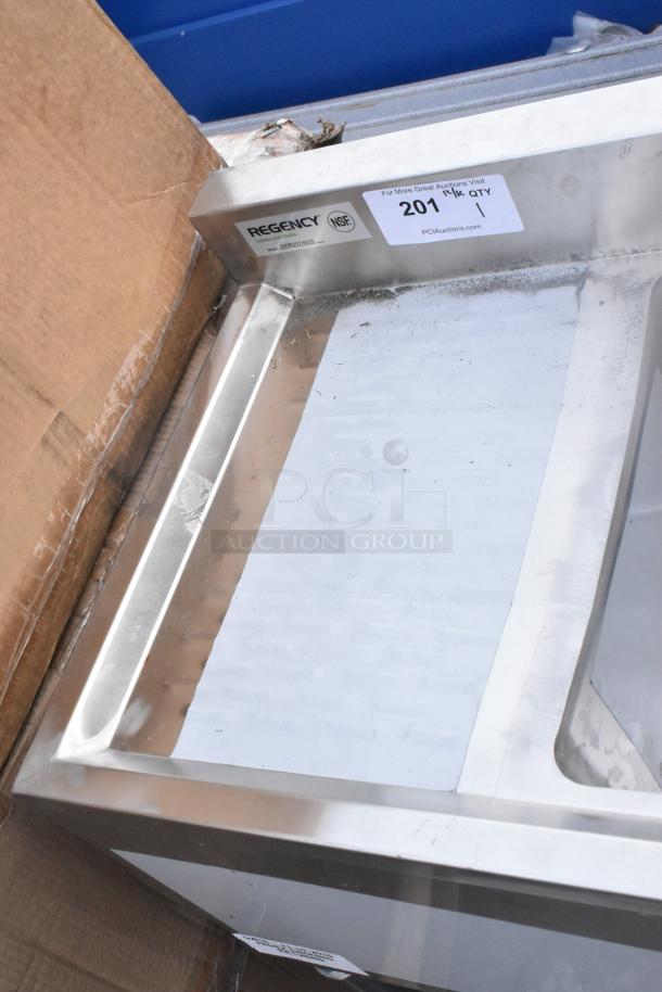 Brand new Regency 600B31014213 underbar sink, 3 bowl, 60"x18¾", with two drainboards. Scratch and dent condition. NSF label visible.