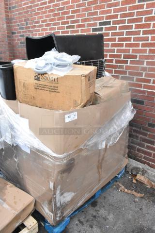 Large cardboard box on pallet containing brand new scratch and dent items. Includes Sabert branded packaging and black poly trash cans. Plastic-wrapped.