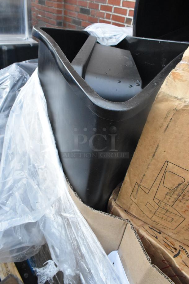 Black poly trash can, part of 12 scratch and dent items; new condition, packaged with other auction items.