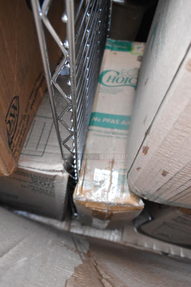 Boxes of scratch and dent items, including EcoChoice packaging, next to a metal rack. Visible wear on boxes.